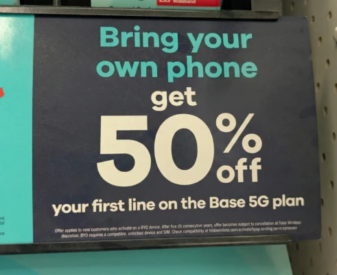 An in-store promotional sign from Target showcasing a Total Wireless offer. Large text on a dark blue background states: