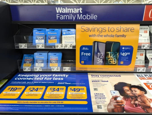 Walmart Family Mobile In Store Signage showcasing phone plans and prices for them