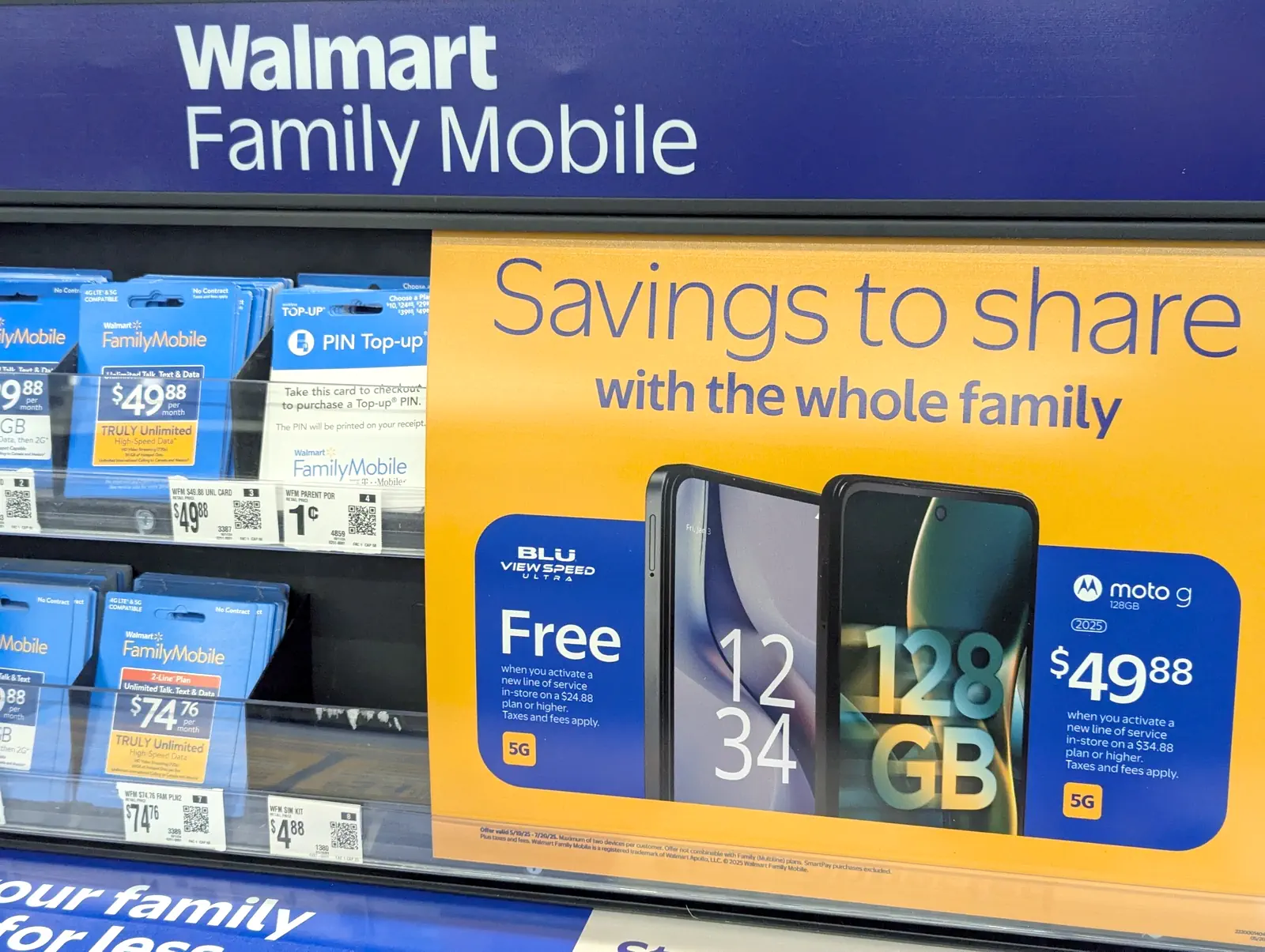 Walmart Family Mobile in Store Signage Free Phone Walmart Family Mobile store signage on display featuring a free Blue View Speed Ultra and $49.88 2025 Moto G